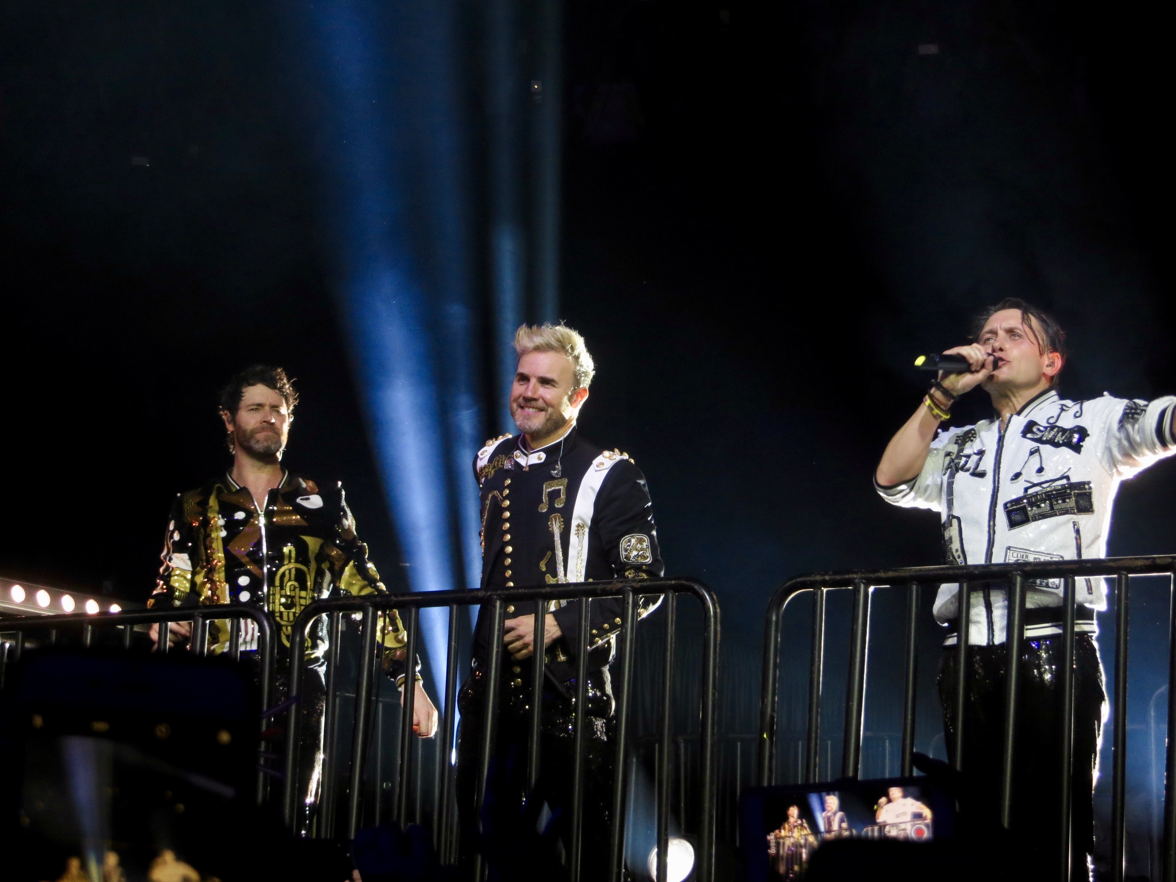 The current line up of Take That (L to R: Donald, Barlow and Owen) performing in Glasgow, Scotland in 2017